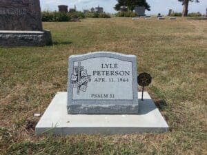 Granite grave marker with cross and inscription