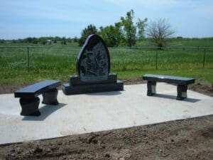 Black granite memorial flanked by benches Catholic cemetery clay center ks