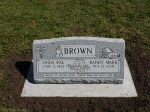 Gray granite headstone with carved inscriptions