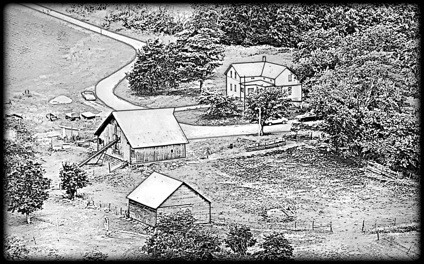 Aerial black-and-white farm with barns and farmhouse