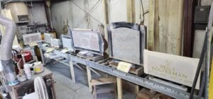 Engraved headstones on workshop conveyor belt
