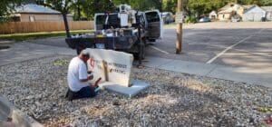 Worker painting United Methodist parking sign