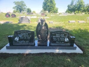 Double black gravestone with angel centerpiece