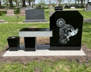Black granite headstone with motorcycle engraving