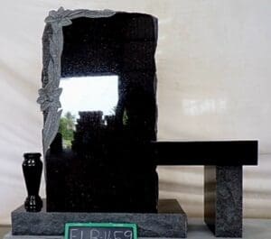 Black granite headstone with bench and vase