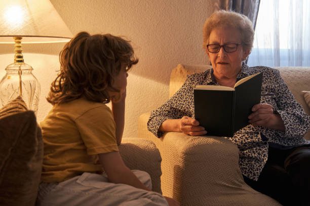 Elderly woman reading to seated child