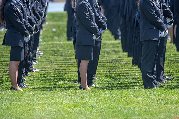 Uniformed officers standing in formation on grass