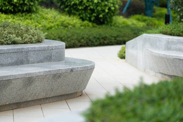 Curved stone benches in landscaped garden