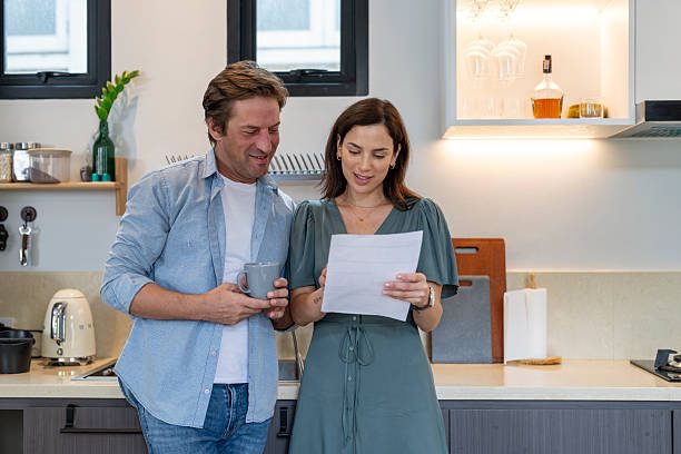 Couple reviewing document in modern kitchen