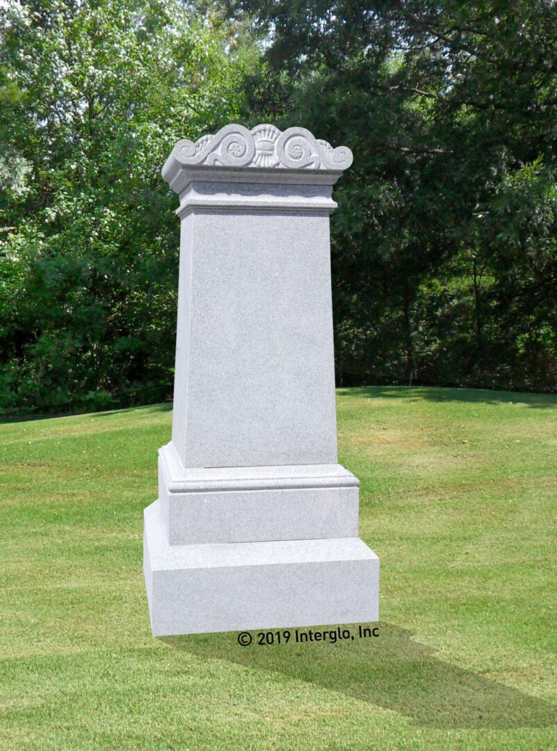 Elegant gray monument with decorative top.