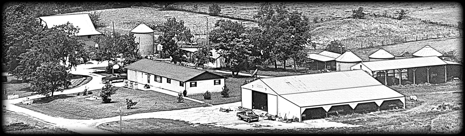 Aerial view of a rural homestead and buildings.