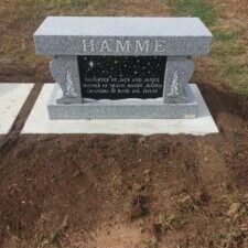 Granite memorial stone with engraved family details.