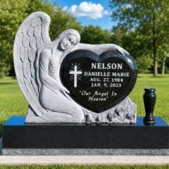 Angel monument with heart-shaped inscription.